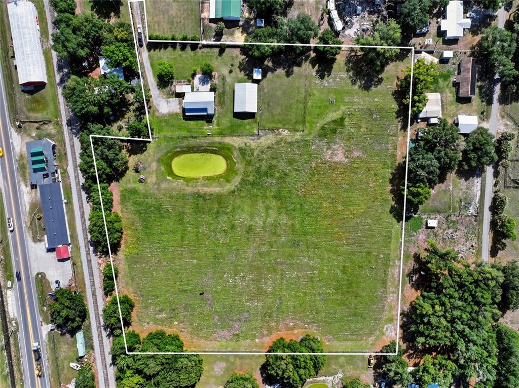 123 South Wiggins Road Plant City, FL 33566 - Photo 4 of 55 a bathroom with swimming pool and trees