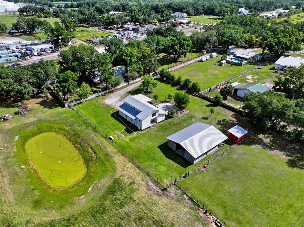 123 South Wiggins Road Plant City, FL 33566 - Photo 49 of 55 an aerial view of a house with swimming pool and green space