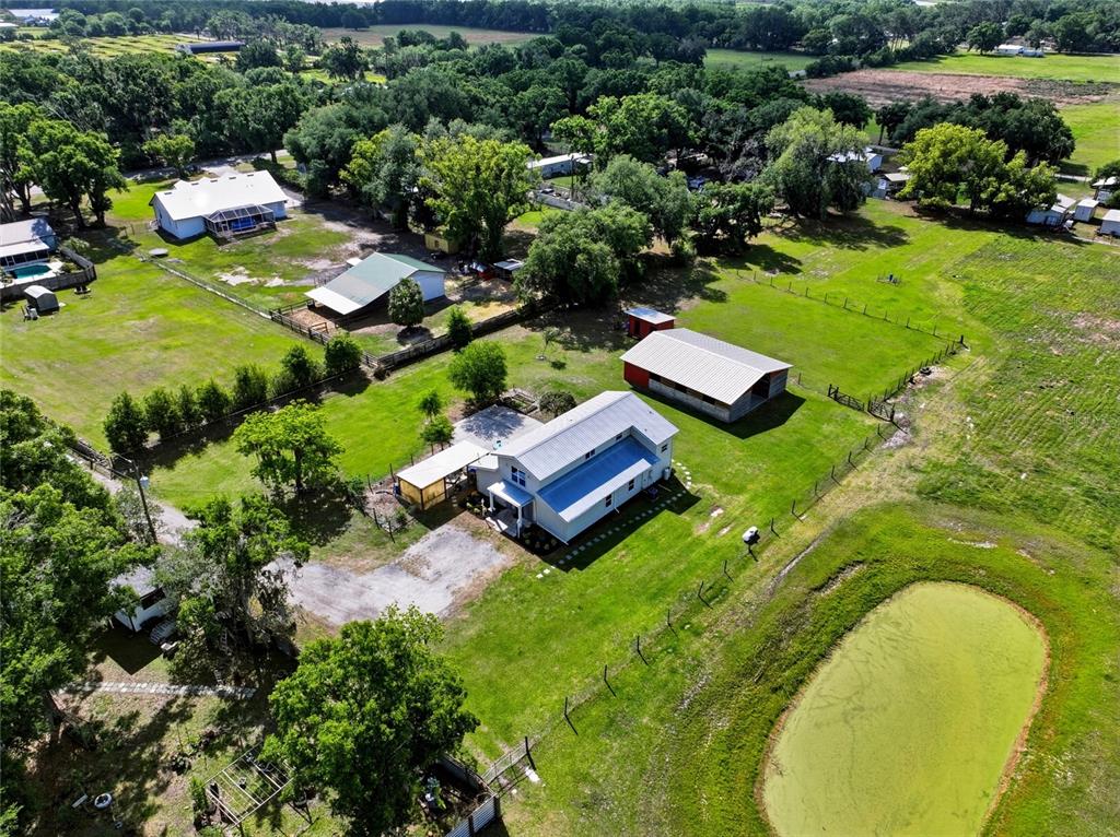 123 South Wiggins Road Plant City, FL 33566 - Photo 50 of 55 an aerial view of a house with a garden and swimming pool
