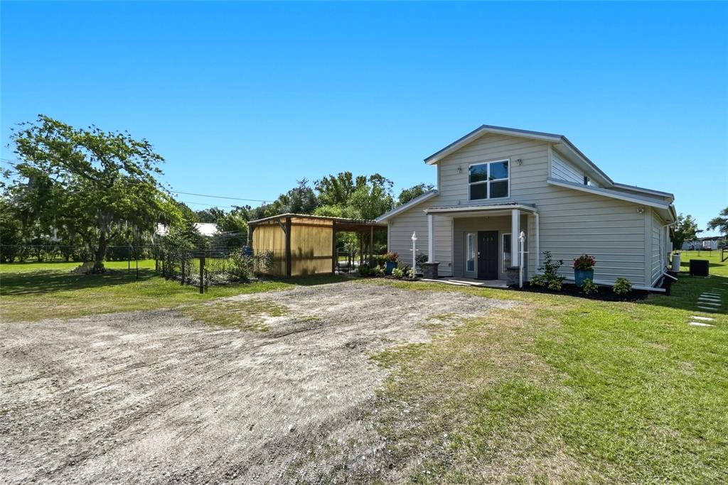 123 South Wiggins Road Plant City, FL 33566 - Photo 55 of 55 a front view of a house with a yard and garage