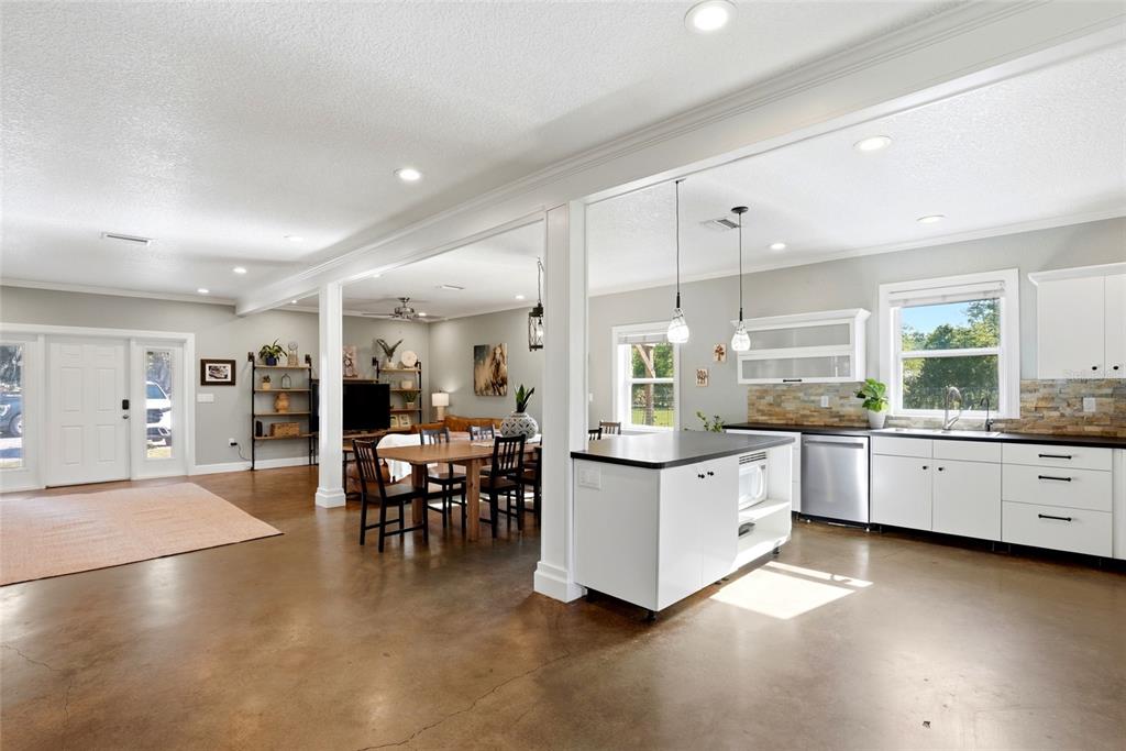 123 South Wiggins Road Plant City, FL 33566 - Photo 10 of 55 a large white kitchen with lots of counter space dining table and chairs