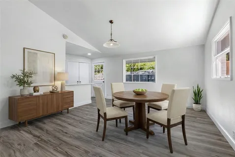 a view of a dining room with furniture window and wooden floor