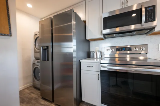 a stove top oven sitting inside of a kitchen