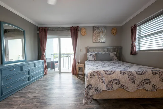 a bedroom with a large bed and a large window