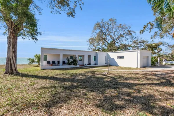 a view of a house with a yard and tree