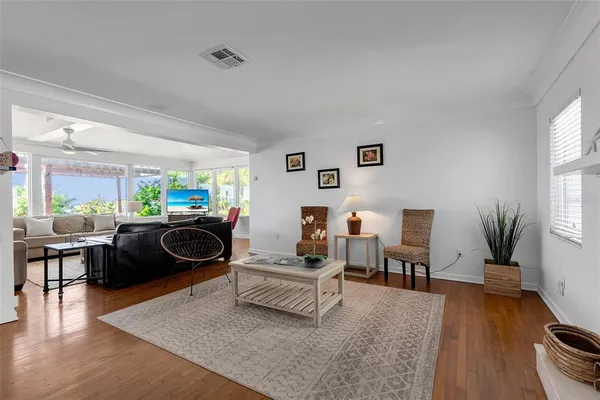 a living room with furniture and wooden floor