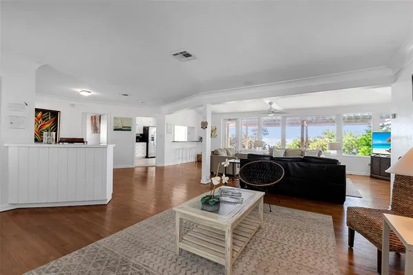 a living room with furniture and a wooden floor