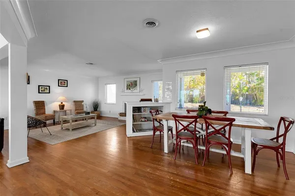 a view of a dining room with furniture window and wooden floor