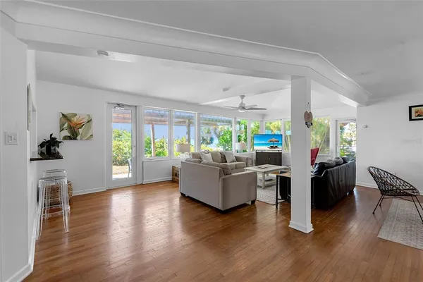 a living room with furniture and a wooden floor