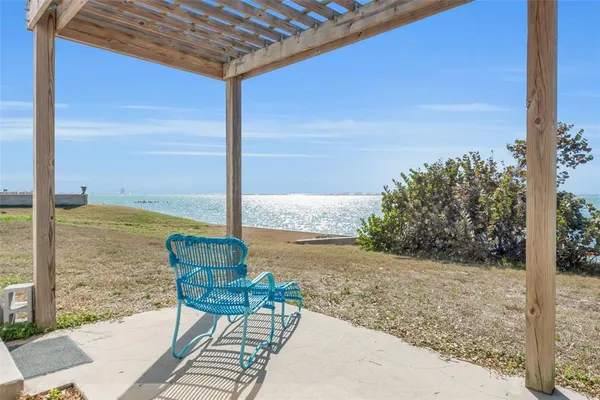 a view of a patio with lawn chairs floor to ceiling window and wooden floor