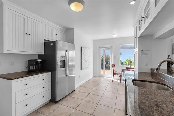 a kitchen with stainless steel appliances granite countertop a refrigerator and a sink