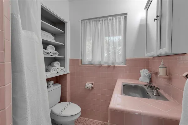 a bathroom with a sink a toilet and vanity