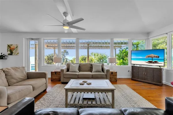 a living room with furniture a large window and a table