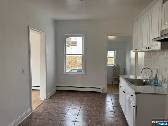 a kitchen with granite countertop a sink and cabinets