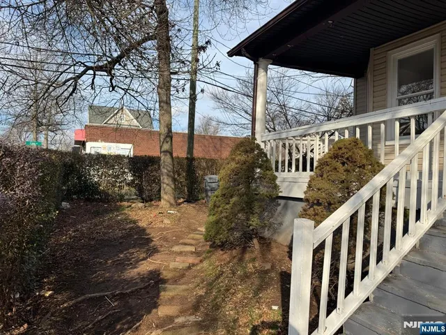 a view of balcony with wooden floor and fence