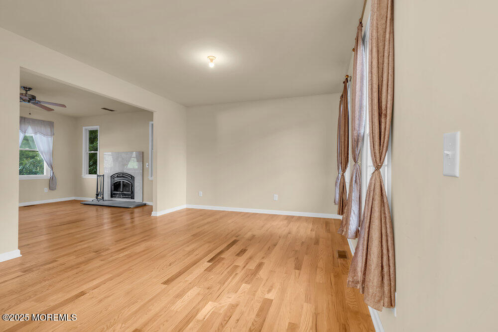 6 Eagle Ridge Lane West Creek, NJ 08092 - Photo 11 of 61 an empty room with wooden floor and a fireplace