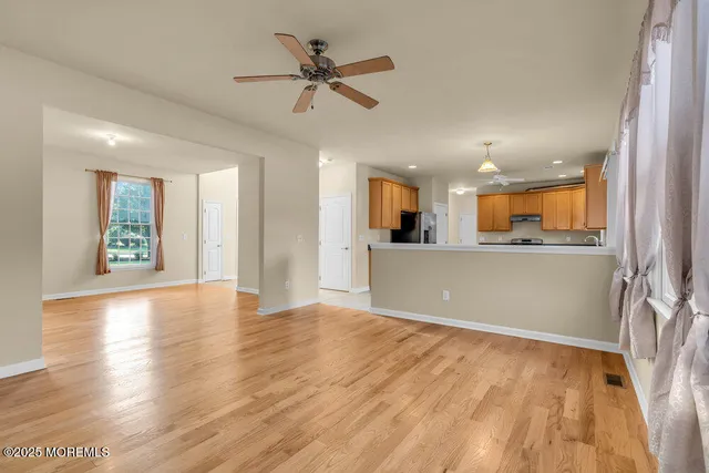 a kitchen with stainless steel appliances a stove top oven a sink and a refrigerator