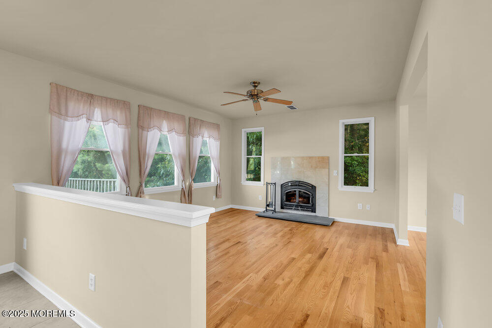 6 Eagle Ridge Lane West Creek, NJ 08092 - Photo 16 of 61 a view of a livingroom with a fireplace a ceiling fan and windows