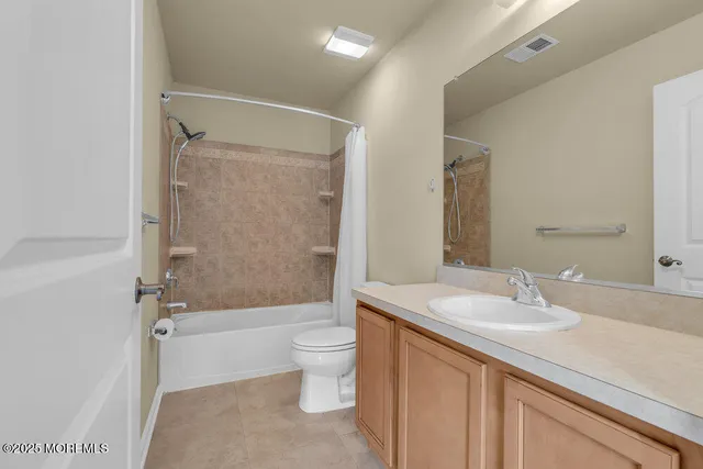 a view of an empty room with a ceiling fan and window