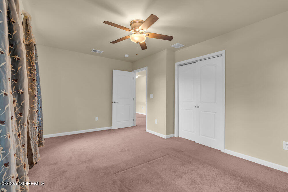 6 Eagle Ridge Lane West Creek, NJ 08092 - Photo 33 of 61 a view of an empty room with a ceiling fan and window