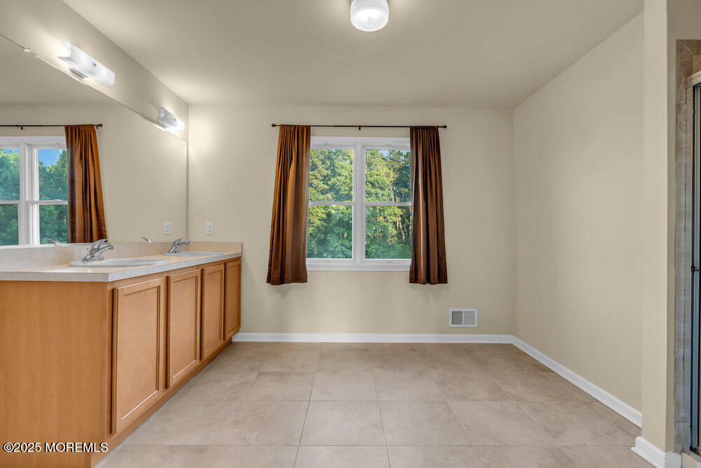 6 Eagle Ridge Lane West Creek, NJ 08092 - Photo 40 of 61 a bathroom with a granite countertop sink and a window