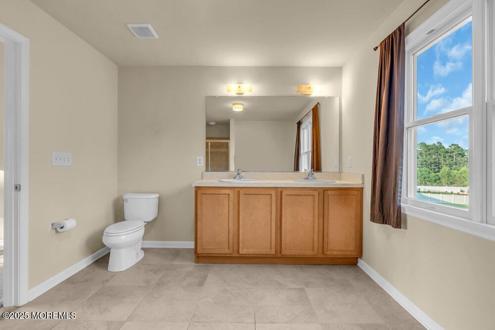 6 Eagle Ridge Lane West Creek, NJ 08092 - Photo 41 of 61 a bathroom with a toilet sink and a mirror
