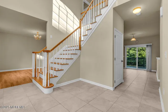 an empty room with wooden floor and a fireplace