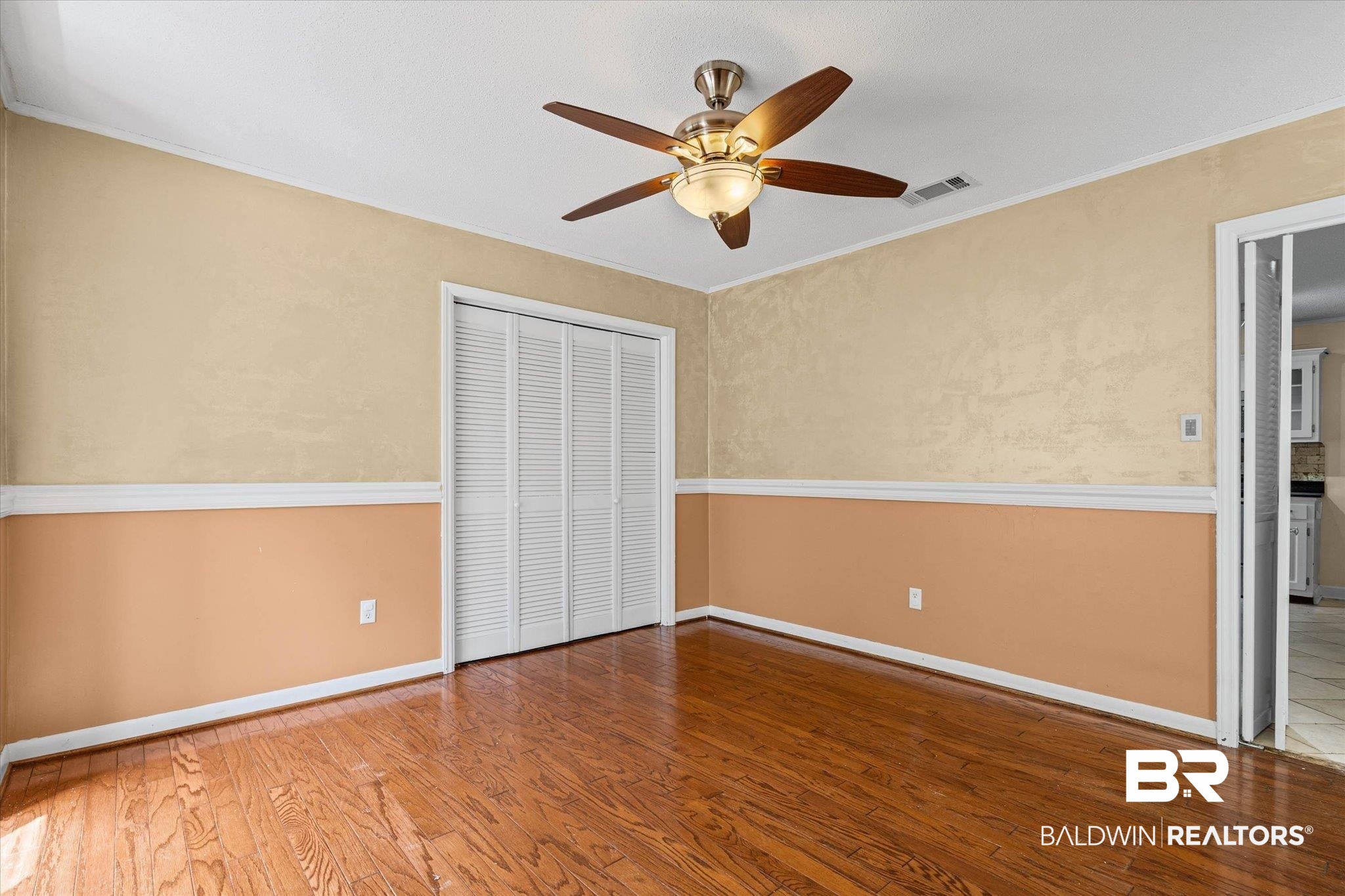 3724 Claridge Road South Mobile, AL 36608 - Photo 19 of 42 Unfurnished bedroom featuring wood finished floors, ornamental molding, ceiling fan, and a closet