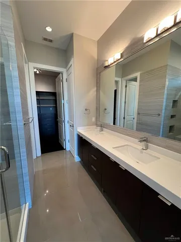 a bathroom with a double vanity sink and a mirror