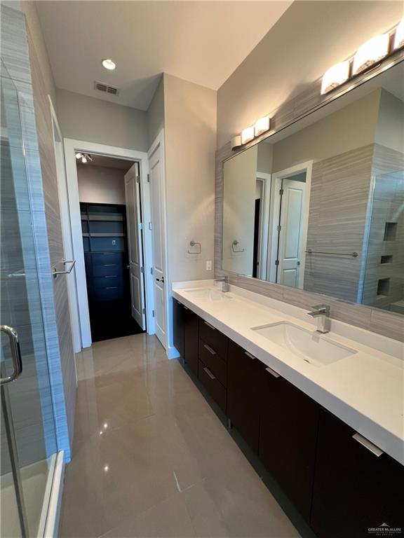 4208 Wichita Avenue McAllen, TX 78503 - Photo 16 of 24 a bathroom with a double vanity sink and a mirror