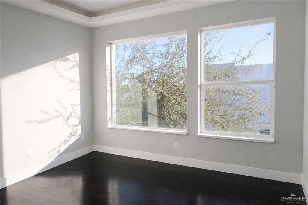 4208 Wichita Avenue McAllen, TX 78503 - Photo 20 of 24 a view of an empty room with wooden floor and a window