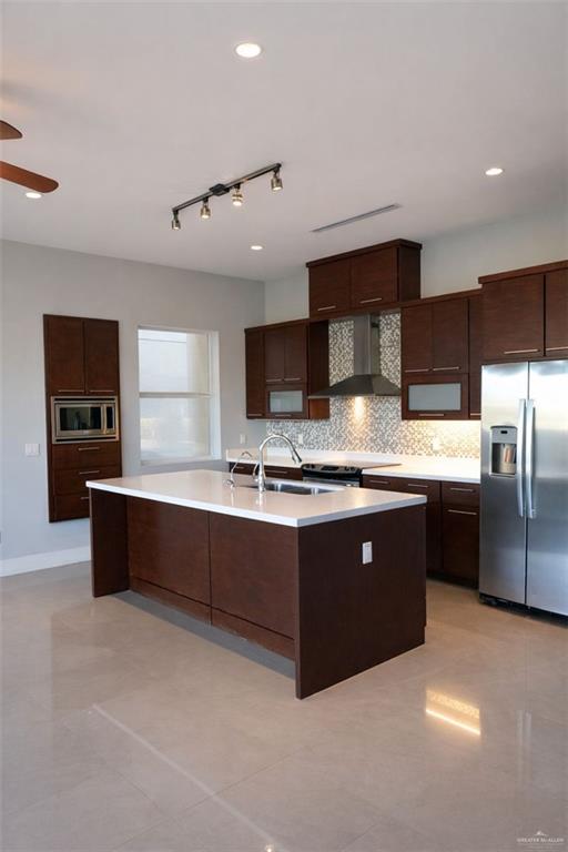 4208 Wichita Avenue McAllen, TX 78503 - Photo 8 of 24 a large kitchen with stainless steel appliances granite countertop a large counter top and stove