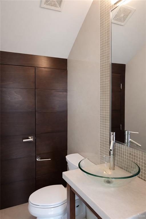 4208 Wichita Avenue McAllen, TX 78503 - Photo 10 of 24 a bathroom with a sink a toilet and shower