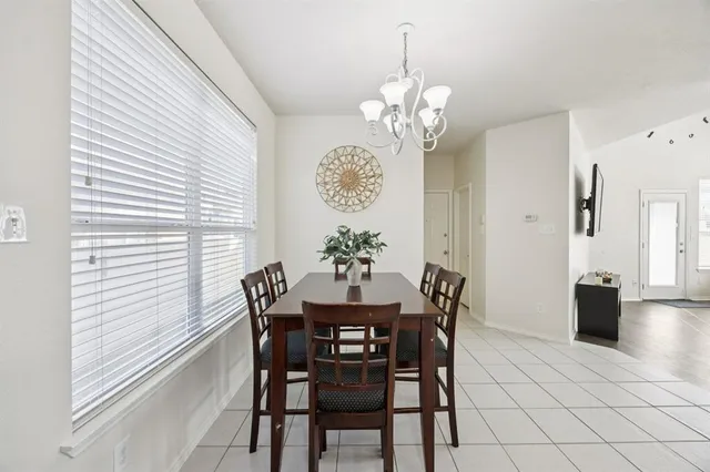 a view of a dining room with furniture and chandelier