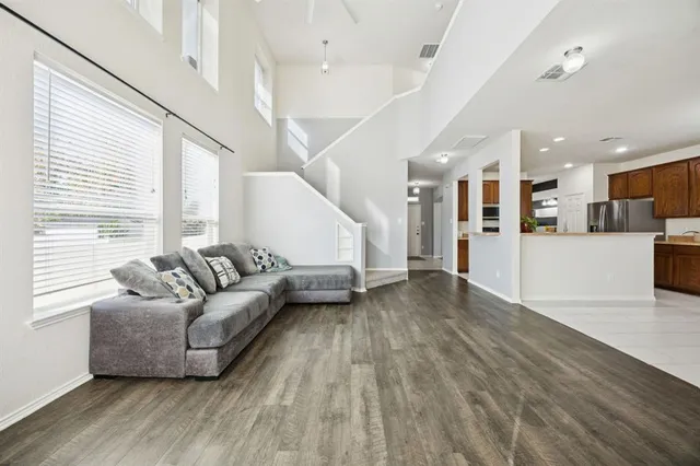 a living room with furniture and kitchen view