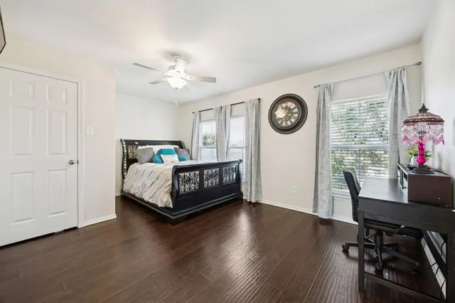 a bed room with a bed mirror and a desk