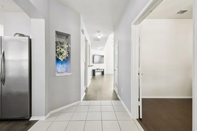 a view of a hallway view with wooden floor and staircase