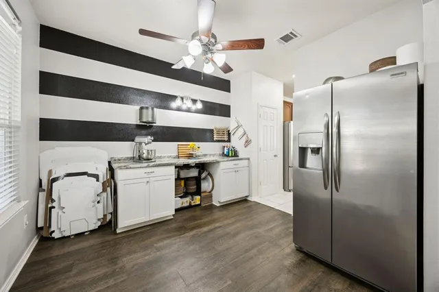 a kitchen with stainless steel appliances a refrigerator sink and microwave