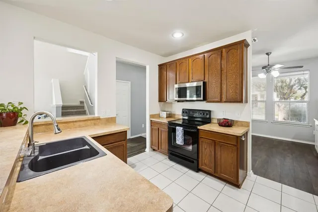 a kitchen with stainless steel appliances granite countertop a sink and a stove