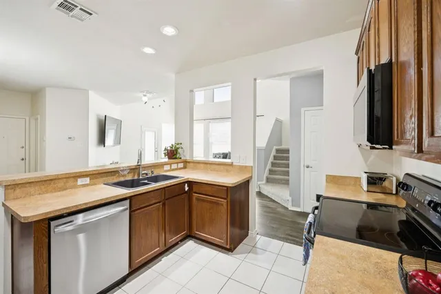 a kitchen with a sink stove and cabinets