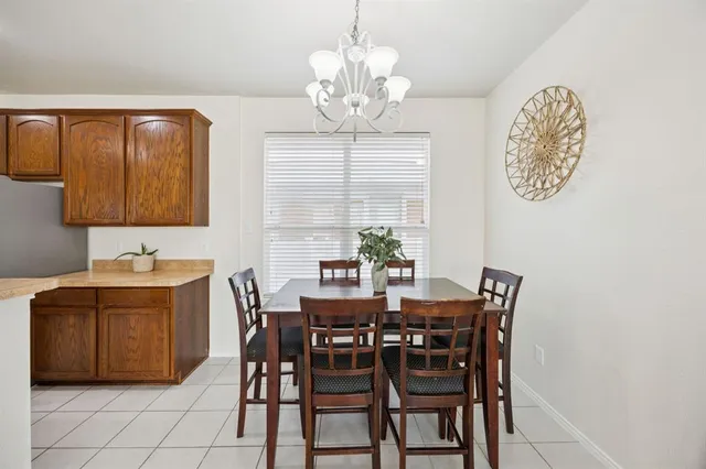 a view of a dining room with furniture and chandelier