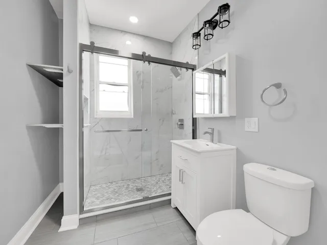 a bathroom with a sink toilet and shower