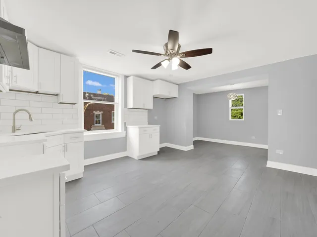 a view of a kitchen with a sink dishwasher cabinets and a kitchen