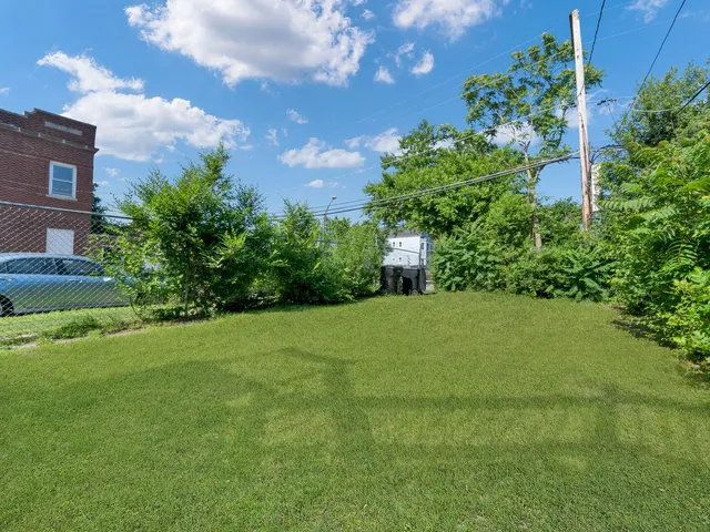 a yellow house sitting in middle of the grass