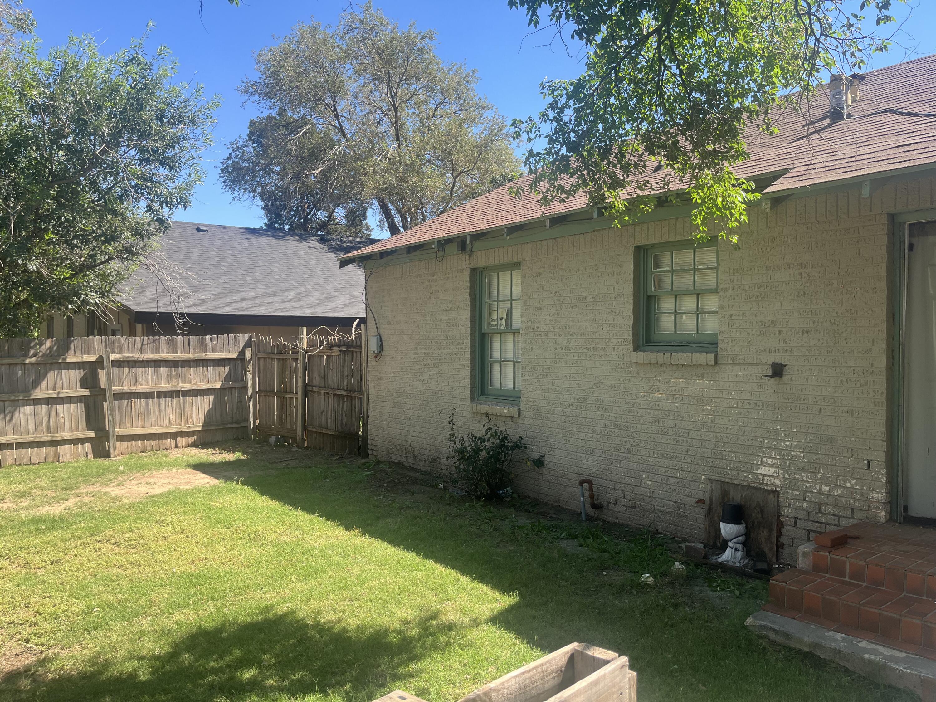 2206 26th Street Lubbock, TX 79411 - Photo 13 of 15 a view of a backyard with a garden and tree