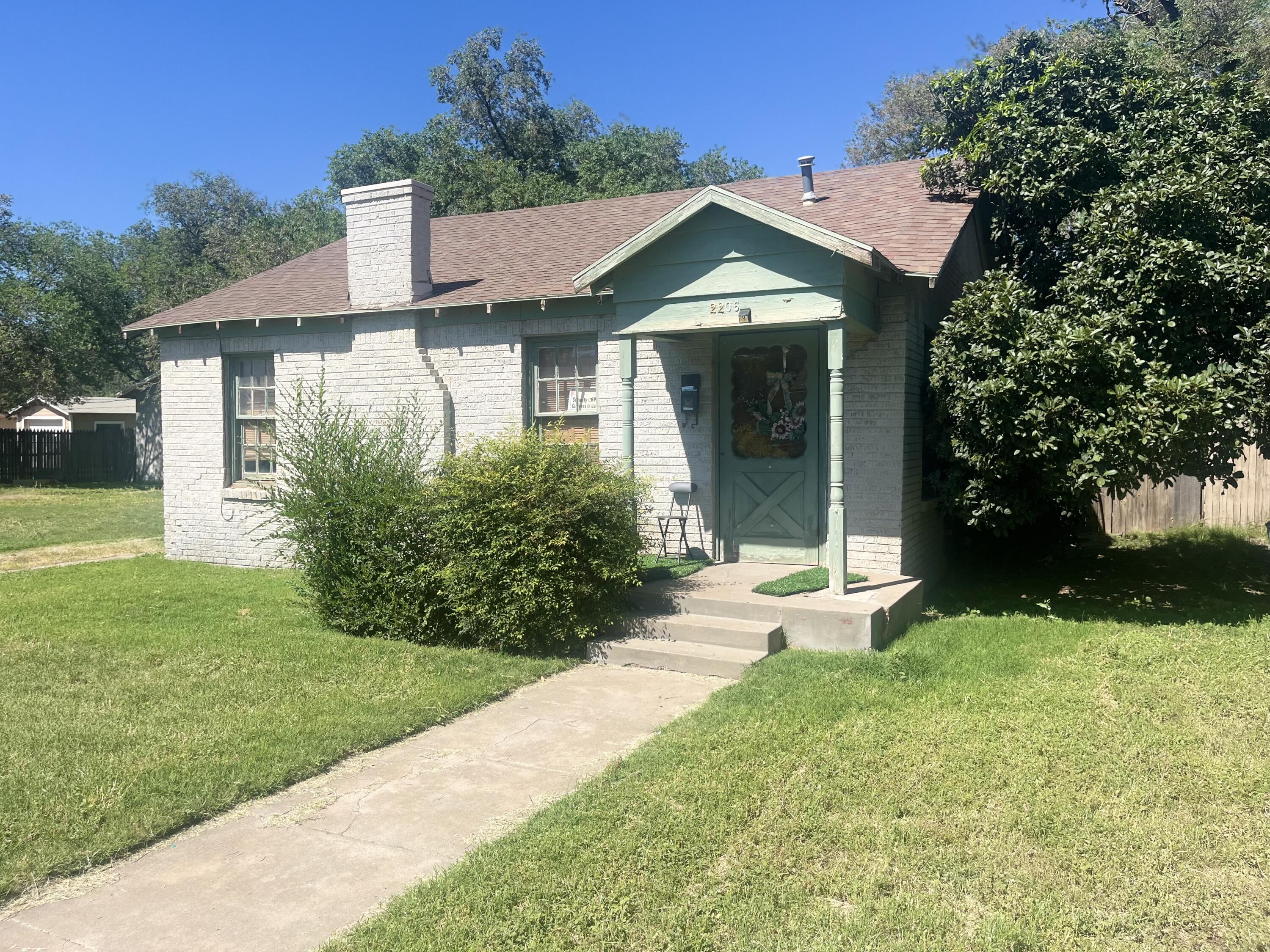 2206 26th Street Lubbock, TX 79411 - Photo 14 of 15 a front view of a house with a yard