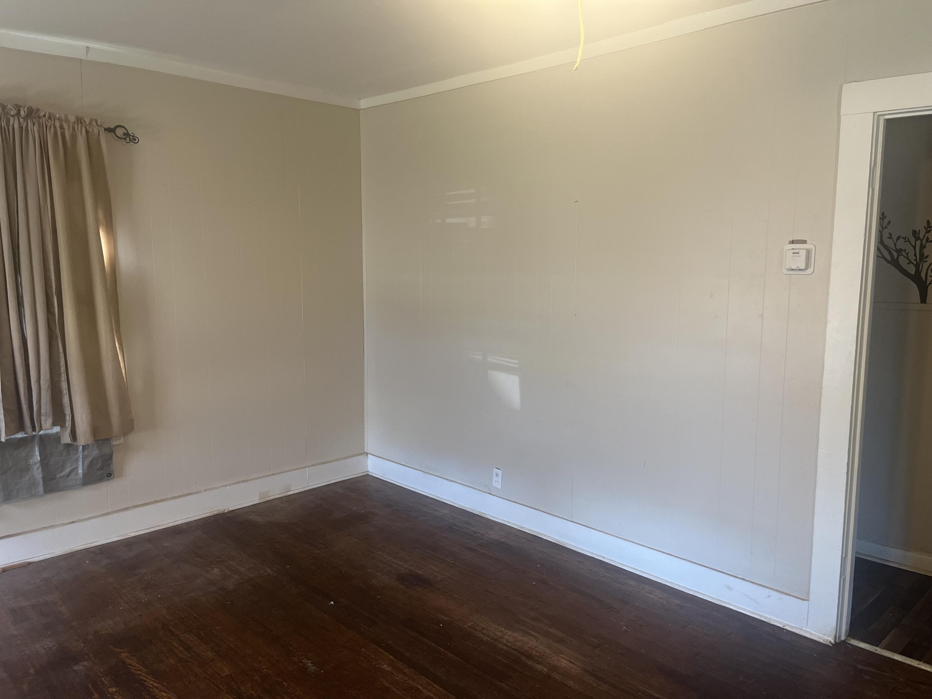 2206 26th Street Lubbock, TX 79411 - Photo 3 of 15 an empty room with wooden floor and a window