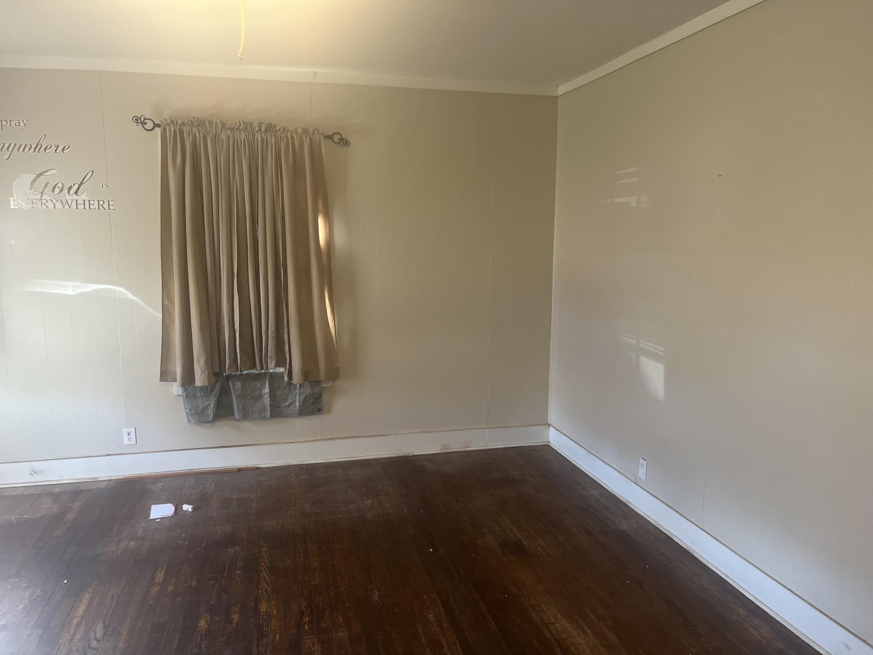 2206 26th Street Lubbock, TX 79411 - Photo 4 of 15 an empty room with wooden floor and windows