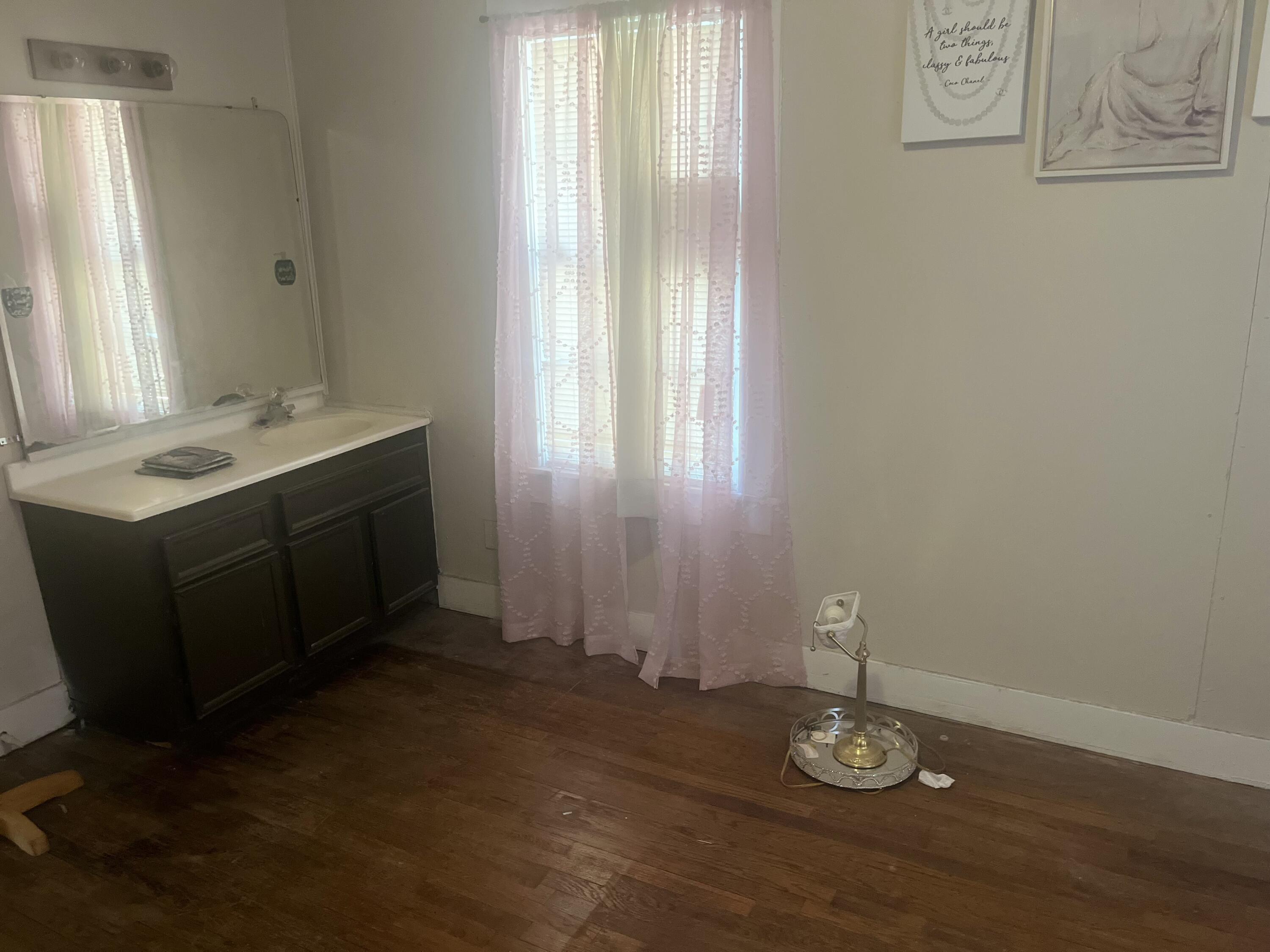 2206 26th Street Lubbock, TX 79411 - Photo 8 of 15 a bathroom with a sink and a mirror