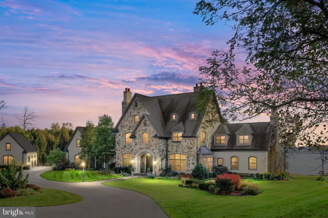 a aerial view of a house with a yard table and chairs